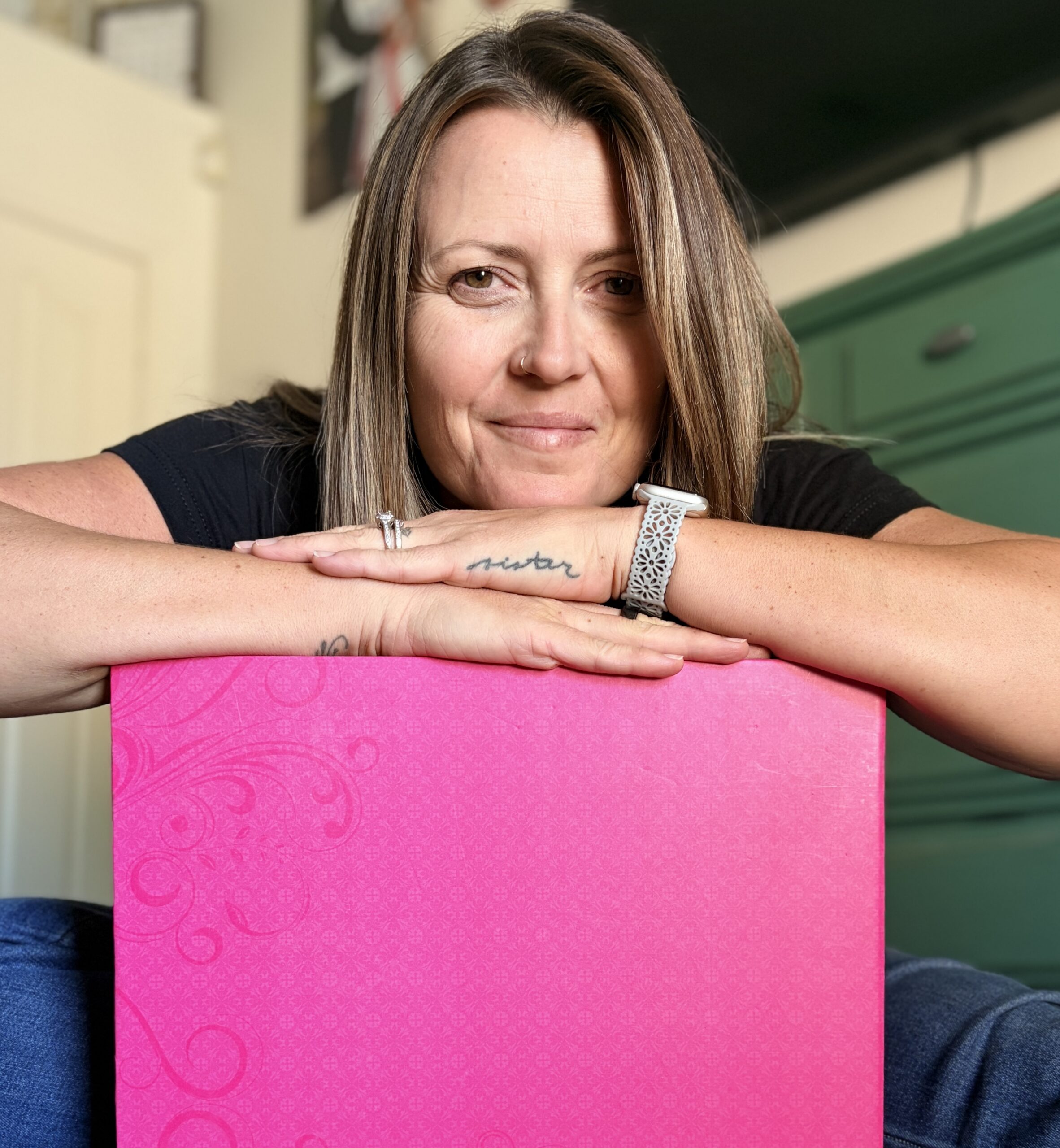 woman leaning on pink album